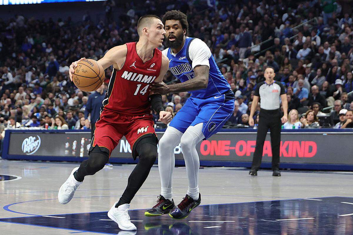 Tyler Herro #14 of the Miami Heat drives to the basket against Naji Marshall #13 of the Dallas Mavericks during the first half at American Airlines Center on December 03, 2025 in Dallas, Texas.