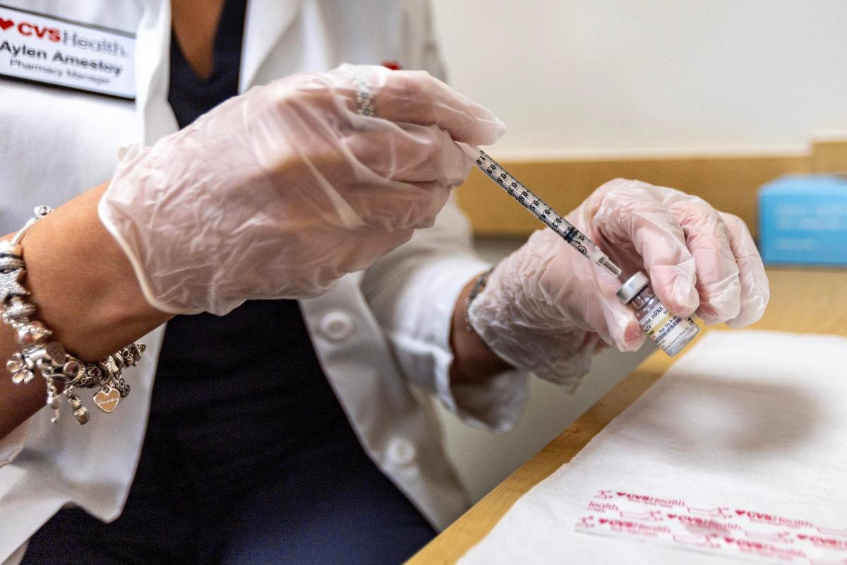 CVS Health Pharmacy Manager Aylen Amestoy prepares to administer the newest COVID-19 vaccine shot at a CVS in Miami, Florida, on Thursday, September 14, 2023.