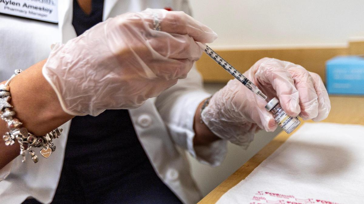 A CVS Health pharmacy manager prepares to administer the newest COVID-19 vaccine shot at a CVS in Miami, Fla., Sept. 14, 2023. Here’s what Centre County residents should know about the new vaccine, including availability in the area.