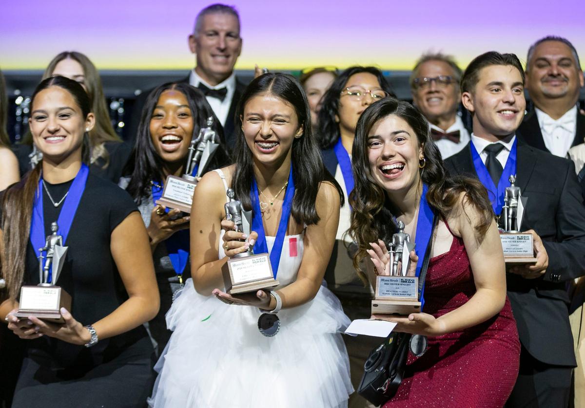 Emily Moreno, center-left, who won the Silver Knight in journalism for Cooper City High, and Heather Suarez, center-right, the Silver Knight winner in art for Hialeah Gardens High, celebrate on stage after receiving their awards during the Miami Herald & el Nuevo Herald 66th Silver Knight Awards ceremony at the James L.&nbsp;Knight&nbsp;Center on Wednesday, May 22, 2024, in downtown Miami, Fla.