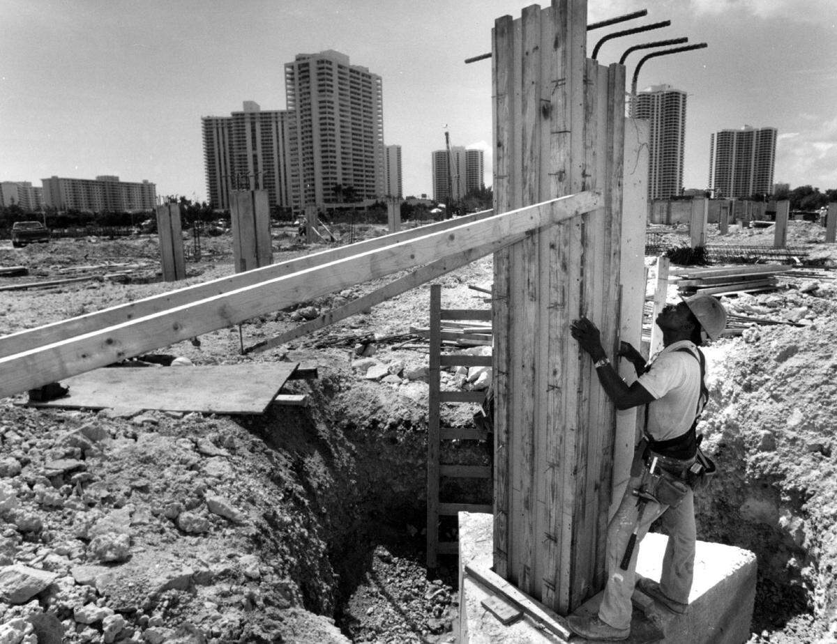 In 1993, carpenter Limonas Clecidor puts a level on one of the foundation legs that would become part of the parking garage at Aventura’s The Yacht Club on East Country Club Drive in Aventura. Nine six-story buildings were planned.