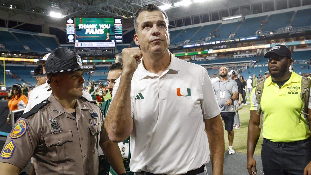 Miami Hurricanes head coach Mario Cristobal fist pumps towards the fans as he walks off the field after defeating NC State Wolfpack during an NCCA football game at Hard Rock Stadium in Miami Gardens, Florida, on Saturday, November 15, 2025. 