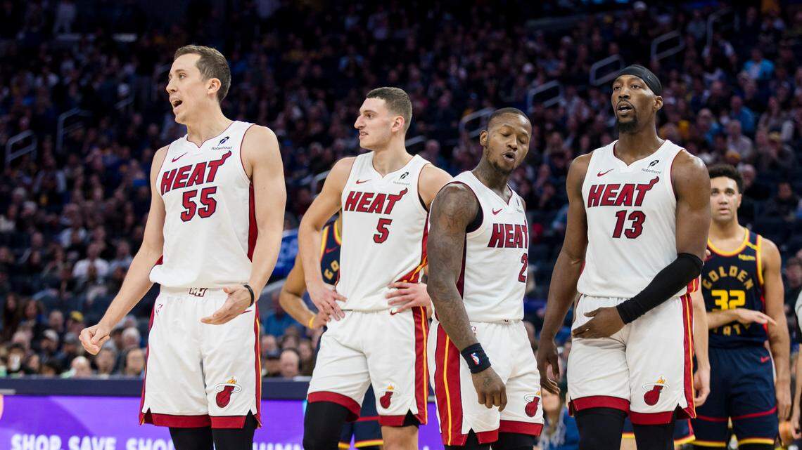 Miami Heat forward Duncan Robinson (55) and forward Nikola Jovic (5) and guard Terry Rozier (2) and center Bam Adebayo (13) react to a foul call during the fourth quarter against the Golden State Warriors.