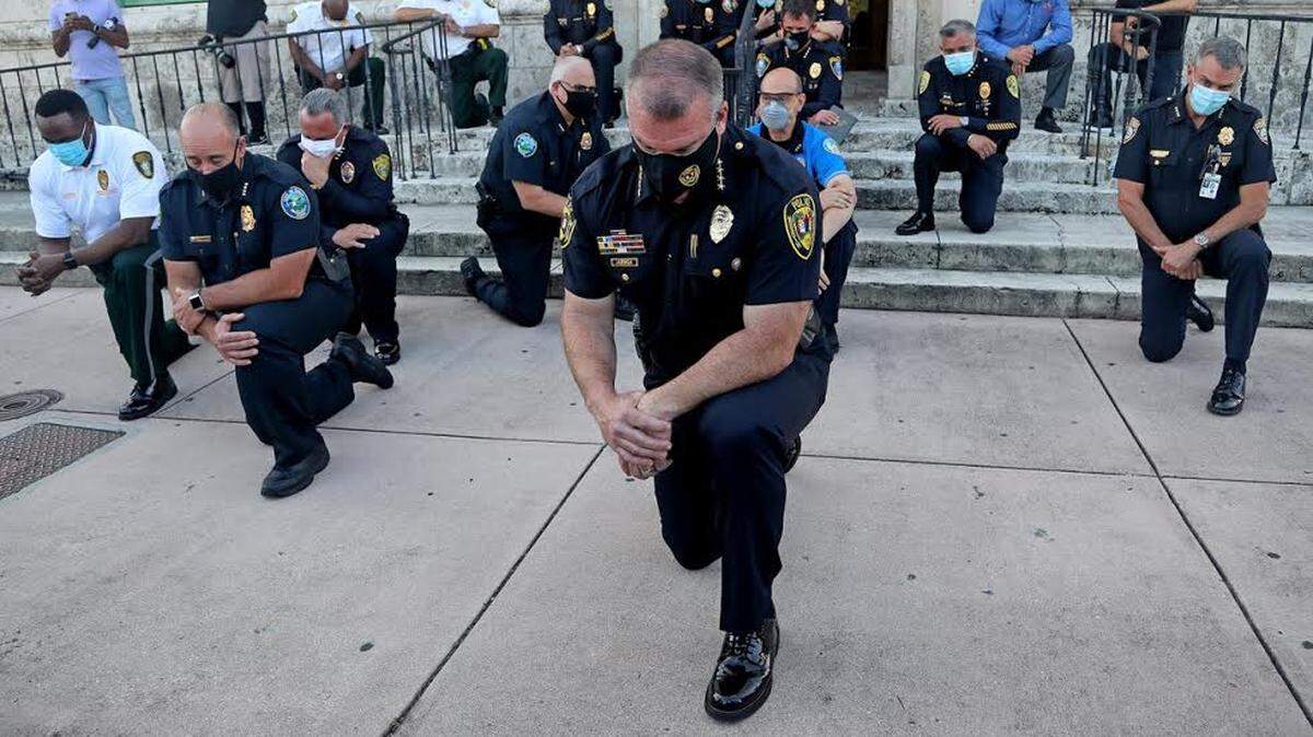 Police chiefs from various cities in Miami-Dade County, including Chief Ed Hudak, of Coral Gables, knelt during protests over George Floyd’s death.