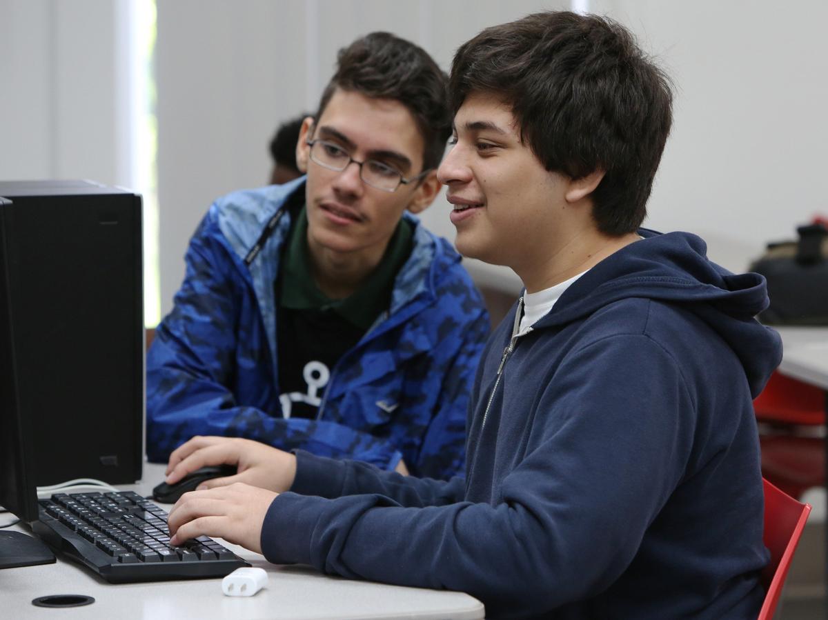 Brandon Garcia-Morales, 17 (L) and Guillermo Trujillo, 17 work on a coding challenge that is part of a web development class at the Big Brothers Big Sisters of Greater Miami campus Monday, July 9, 2018. 600 students, ages 16-18, who quailify for the free lunch program in the Miami-Dade school system attend a camp that teaches them important skills in technology and coding.