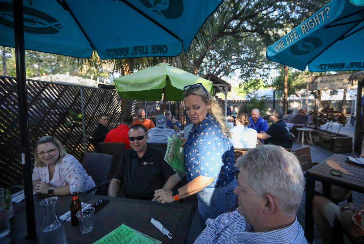Kimberly Platt, chef and owner of The Honu, a tiki-themed bar and restaurant, attends to guests Thursday, April 20, 2023 in Dunedin. Platt is one of the organizers of this year’s Dunedin Pride event.