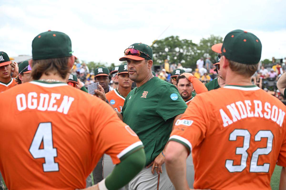 University of Miami baseball coach J.D. Arteaga speaks to the Hurricanes’ players following a 5-3 win over Alabama on Friday in the opening round of the Hattiesburg Regional in Hattiesburg, Mississippi.
