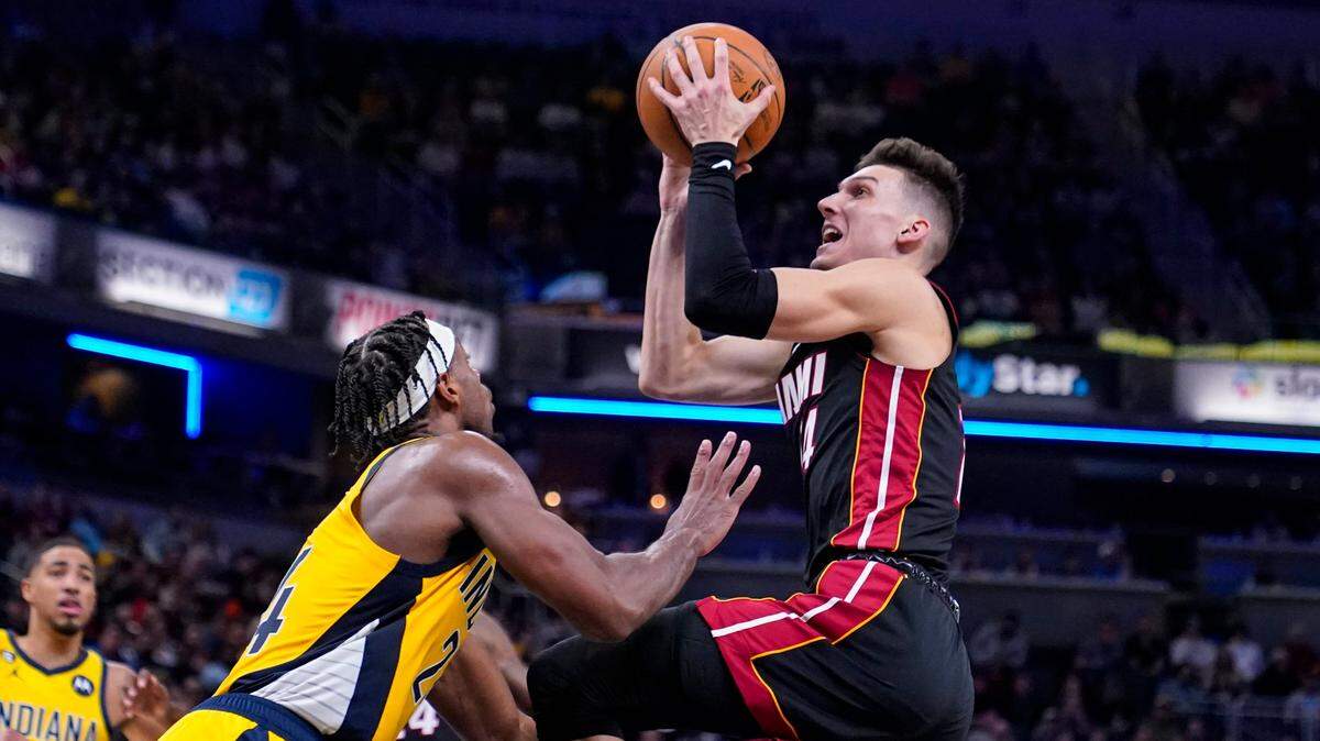 Miami Heat guard Tyler Herro (14) shoots over Indiana Pacers guard Buddy Hield (24) during the first half of an NBA basketball game in Indianapolis, Friday, Nov. 4, 2022.