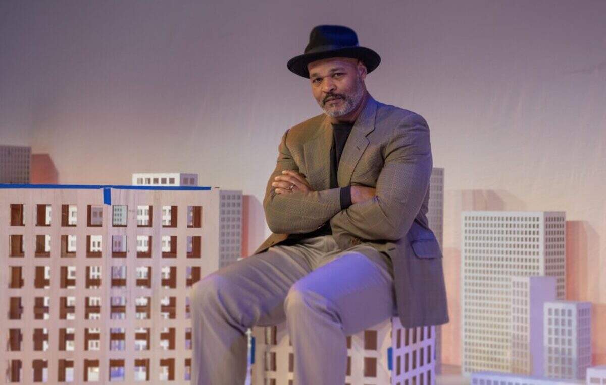Actor Melvin Huffnagle as August Wilson sits atop a scale model off Pittsburgh in “How I Learned What I Learned” at GableStage.