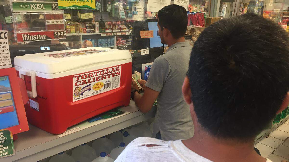 Byron Bentancourt, 29, sends cash home to his family in Honduras for Mother's Day. Immigrants like Bentancourt may be sending higher volumes of cash home in anticipation of an immigration crackdown.