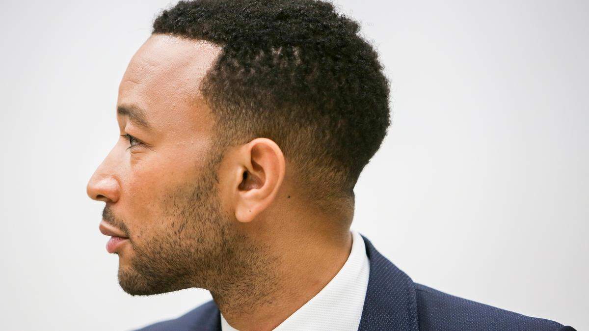Singer, songwriter and actor John Legend listens to Desmond Meade, president of the Florida Rights Restoration Coalition, at an event supporting Florida’s Amendment 4 at Maynard Evans High School in Orlando on Wednesday, Oct. 3, 2018. The amendment would restore the right to vote to nonviolent convicted felons who have served their time.