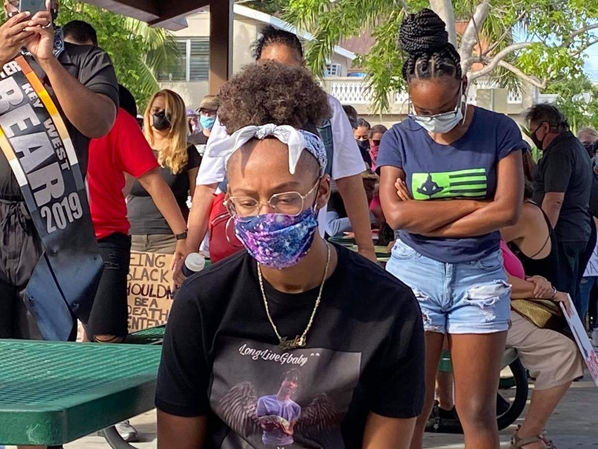 Members of the crowd at a June 1, 2020, protest over the death of George Floyd in police custody in Minnepolis, bow their heads for a moment of silence.