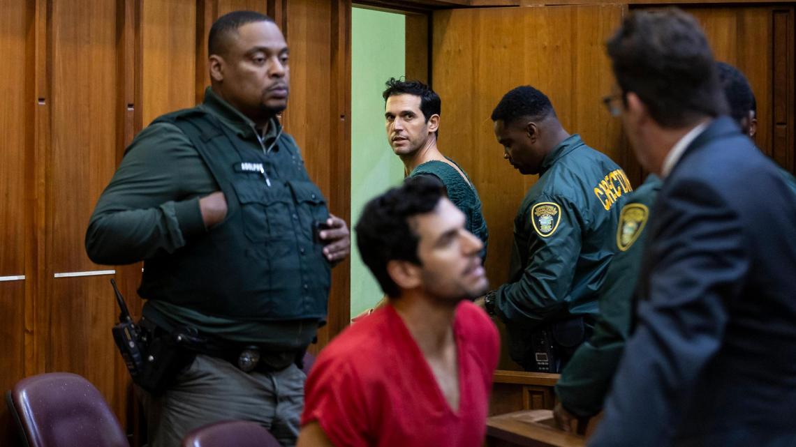 Alon Alexander, 37, top, and his twin brother, Oren, bottom, try to talk to their attorney Joel Denaro after their bond hearing at the Richard E. Gerstein Justice Building on December 13 in Miami. They appeared Friday in federal court in Miami, where they face additional charges.