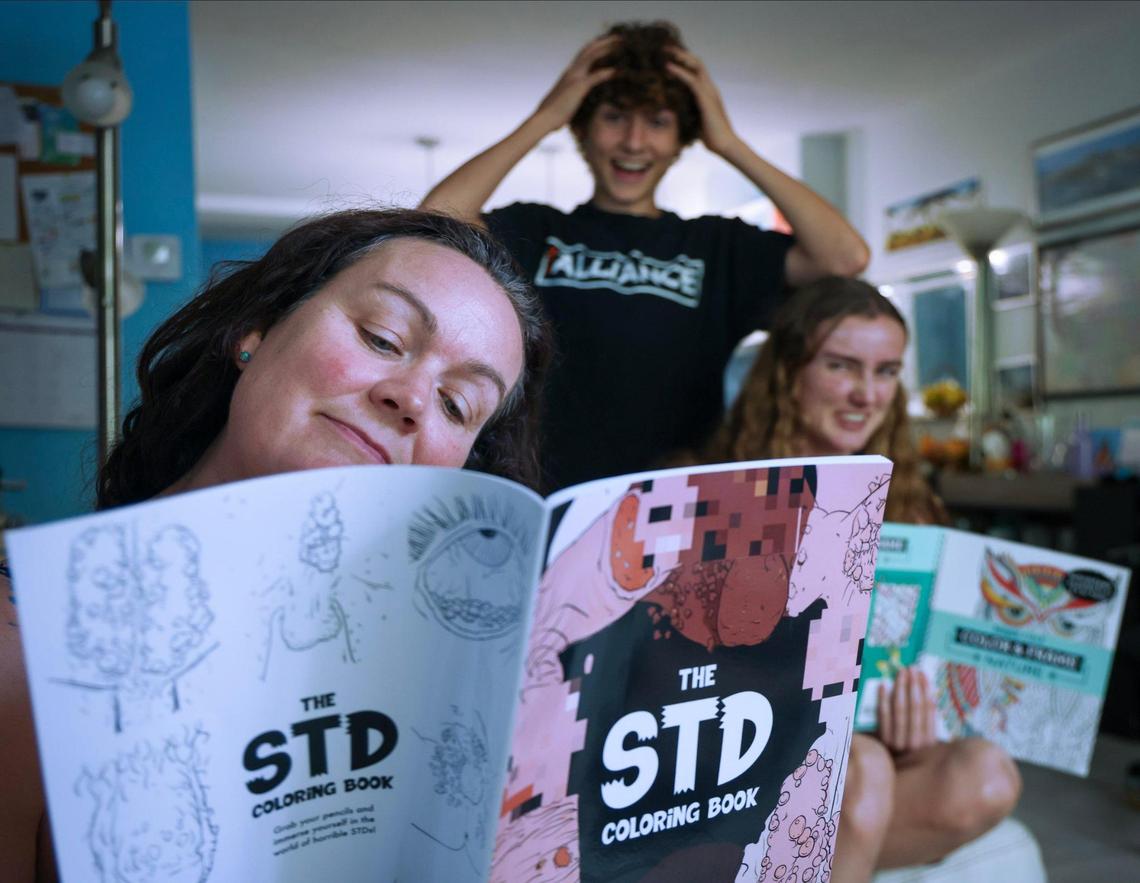 The STD Coloring Book is both informative and thoughtful -- the perfect gift to scare teens into abstinence. Pictured, Liz Zaney, Ryan Zaney, Kaia Zaney