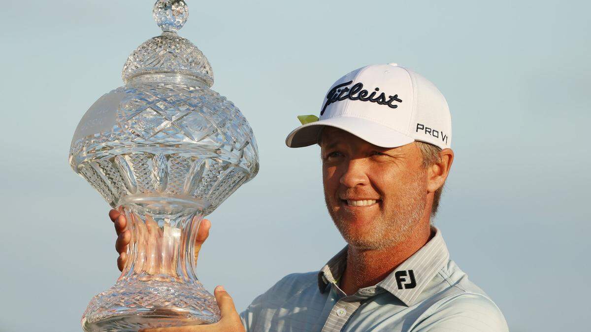 PALM BEACH GARDENS, FLORIDA - MARCH 21: Matt Jones of Australia celebrates with the trophy after winning during the final round of The Honda Classic at PGA National Champion course on March 21, 2021 in Palm Beach Gardens, Florida. (Photo by Cliff Hawkins/Getty Images)
