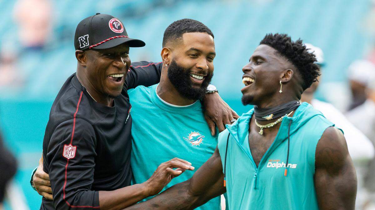 Atlanta Falcons head coach Raheem Morris talks with Miami Dolphins wide receivers Odell Beckham Jr. (3) and Tyreek Hill (10) before their NFL pre-season football game at Hard Rock Stadium on Friday, Aug. 9, 2024, in Miami Gardens, Fla.