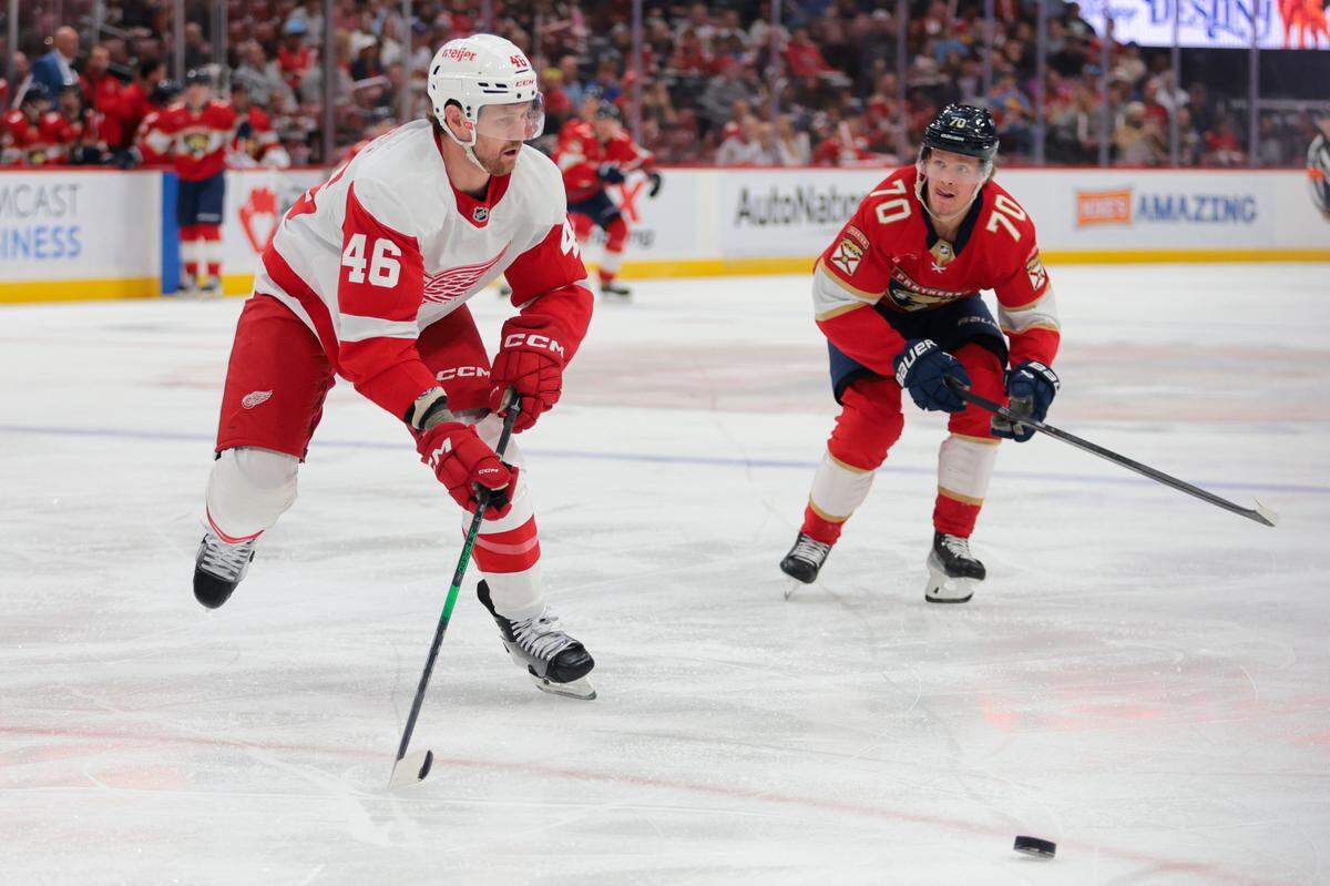 Apr 10, 2025; Sunrise, Florida, USA; Detroit Red Wings defenseman Jeff Petry (46) moves the puck ahead of Florida Panthers center Jesper Boqvist (70) during the first period at Amerant Bank Arena. Mandatory Credit: Sam Navarro-Imagn Images