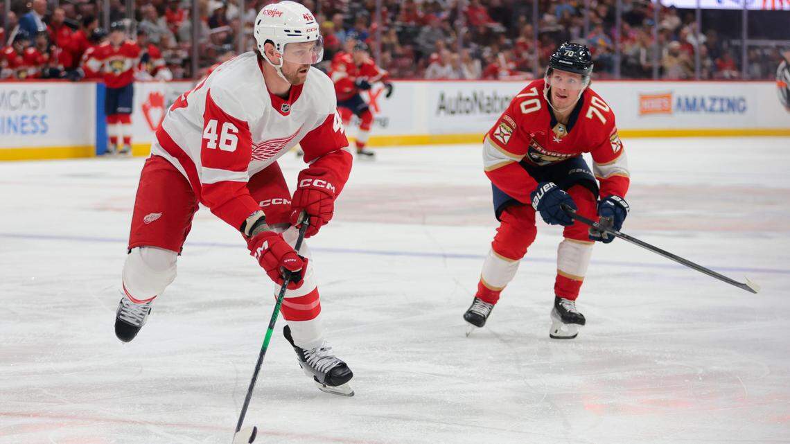Apr 10, 2025; Sunrise, Florida, USA; Detroit Red Wings defenseman Jeff Petry (46) moves the puck ahead of Florida Panthers center Jesper Boqvist (70) during the first period at Amerant Bank Arena.