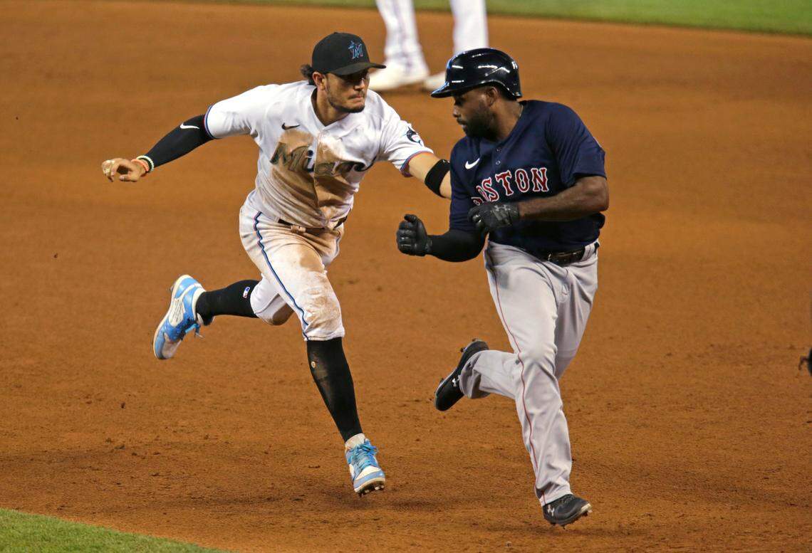 Miami Marlins shortstop Miguel Rojas (19) tags out Boston Red Sox center fielder Jackie Bradley Jr. (19) during the eight inning of a baseball game at at Marlins Park in Miami on Thursday, September 17, 2020.