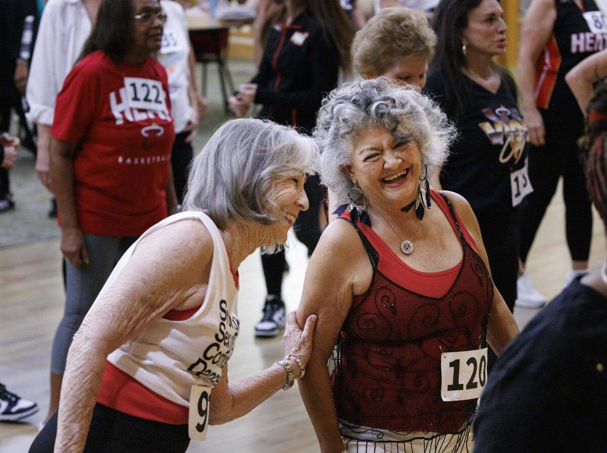 Candy Raphan, left, laughs with Amalia Bauza during the HEAT Golden Oldies auditions for the Miami Heat senior dance team on Thursday, Sept. 25, 2025, at Southwest Focal Point Community Center in Pembroke Pines, Fla.
