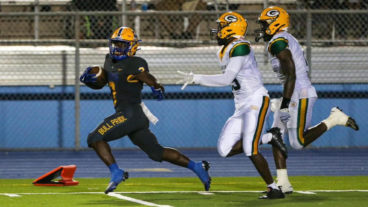 Northwestern Bulls running back Jamari Ford (3) runs with the football ahead of Jackson Generals defenders during the first quarter of a high school football game at Traz Powell Stadium in Miami, Florida, on Friday, September 1, 2022.
