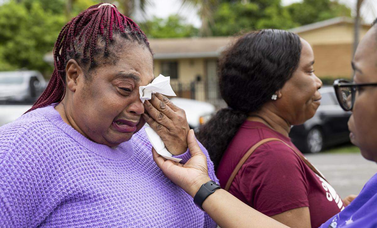Shakira England, right, helps Claudette Everett wipe tears as they attend a vigil for the late Doreen Richards Broadbelt at her home on Tuesday, Sept. 9, 2025, in Miami Gardens, Fla. Broadbelt, 71, was walking to her job at Walmart when a dog attacked and fatally mauled her near her home on Labor Day, police said.