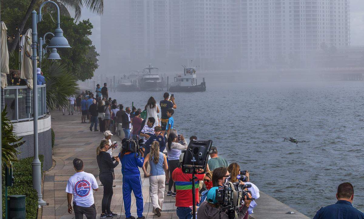 Crowds watched the implosion of the Mandarin Oriental, Miami on Brickell Keyfrom a baywalk.