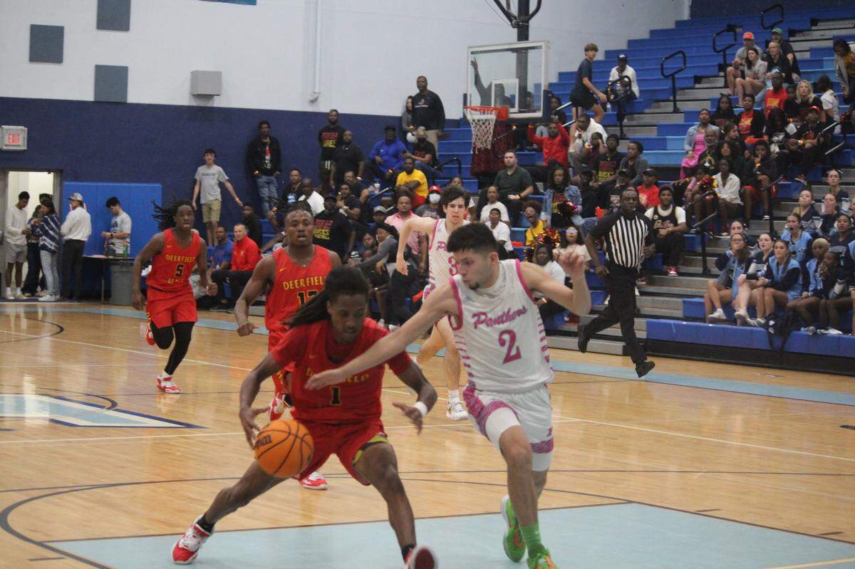 Deerfield Beach’s Joe Barksdale goes up for a layup as Palmetto’s Matthew Marrena tries to cut him off during the Bucks’ 64-55 win over the Panthers on Tuesday night in a Region 4-7A semifinal at Palmetto.