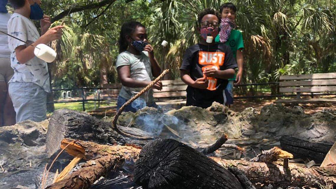 Kids enjoy toasting marshmallows over a campfire at EcoAdventures summer camp, run by Miami-Dade Parks, Recreation and Open Spaces.