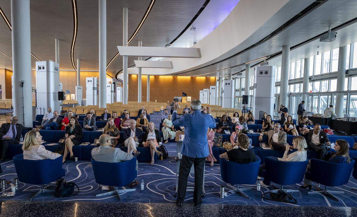 Miami, FL, October 1, 2025 - Richard E Sasso, Chairman of MSC Cruises North America, center wearing blue jacket, speaks to a group that attended a discussion titled, Building for the Future: Shaping Climate-Resilience at the MSC Miami Cruise Terminal in Port Miami. Inspired by the Herald's ongoing Building for the future series, this discussion featured leaders in development, government, construction and real estate to explore strategies for shaping a climate-resilient South Florida.