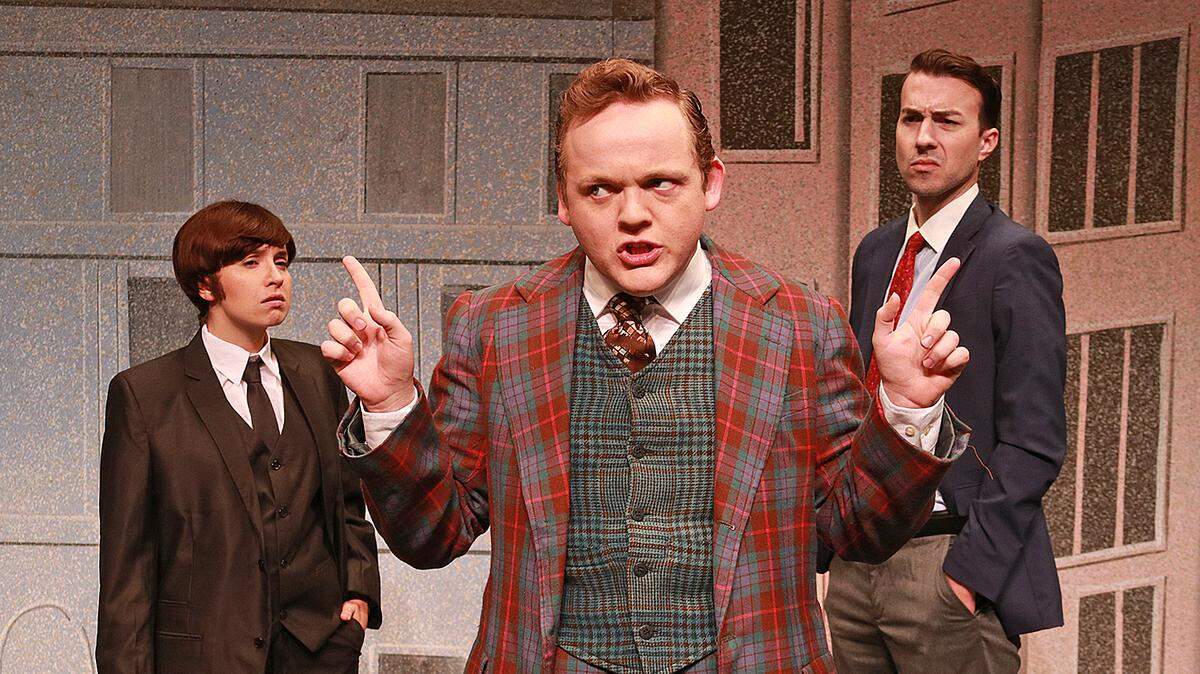 Wesley Slade, center, juggles the demands of bosses played by Krystal Millie Valdes, left, and Cliff Burgess in ‘One Man, Two Guvnors’ at Actors’ Playhouse.
