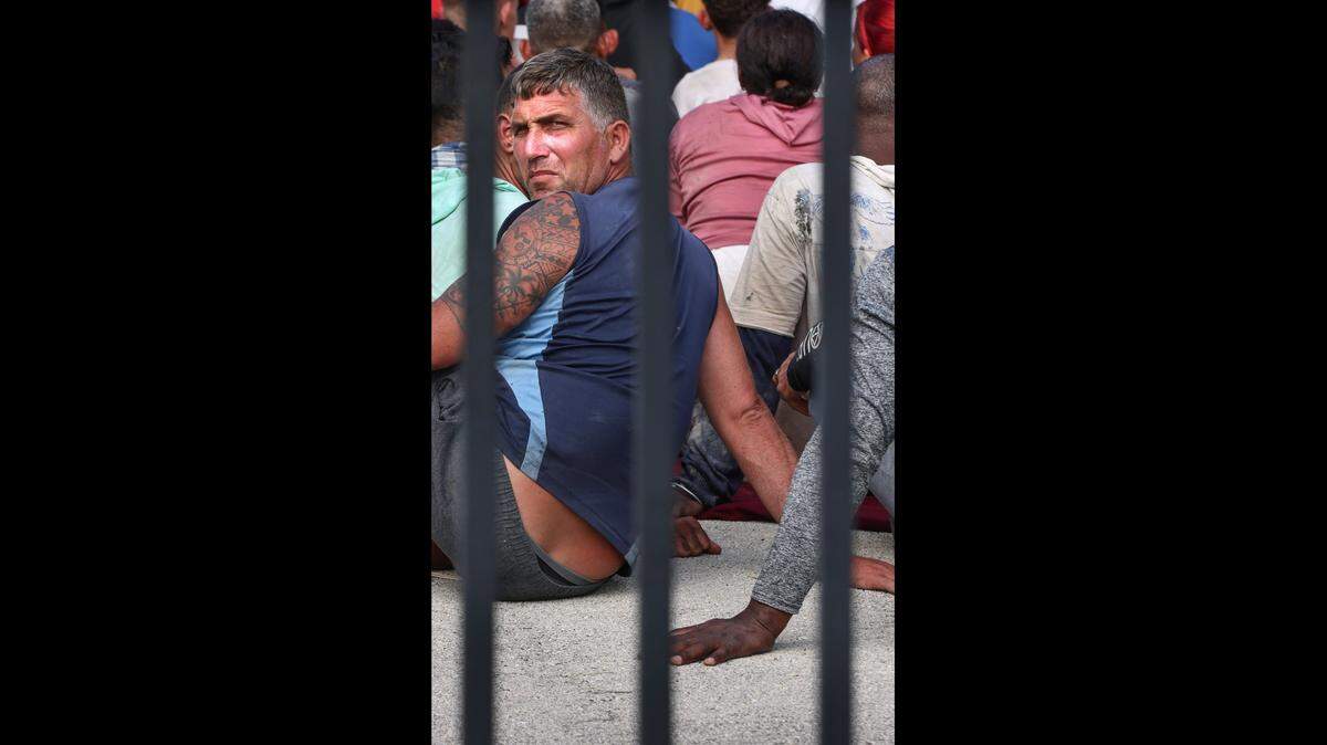 Cuban migrants sit on the ground while waiting to be processed at the U.S. Border Patrol station in Marathon in the Florida Keys on Wednesday, Jan. 4, 2023. About 40 men, women and small children were among those at the Border Patrol center. They were among hundreds of Cuban migrants, and one group of over 100 men and women from Haiti, who’ve landed across the island chain since the end of last week.