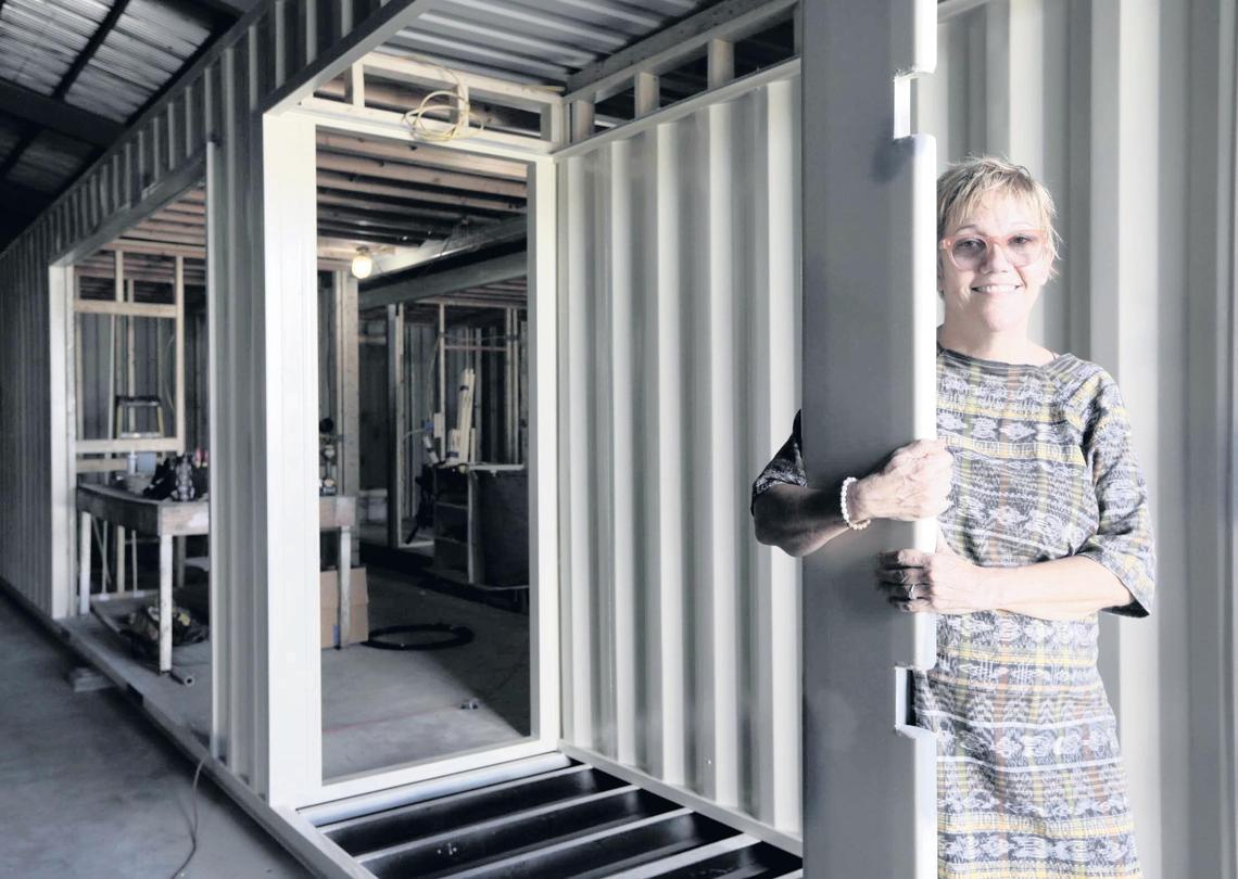 Gayle Zalduondo, founding partner at Little River Box Company, poses in front of a cargo container being converted into a house at the company. Out back, she has two cargo containers slated for a one-bedroom house on a small lot in South Miami.