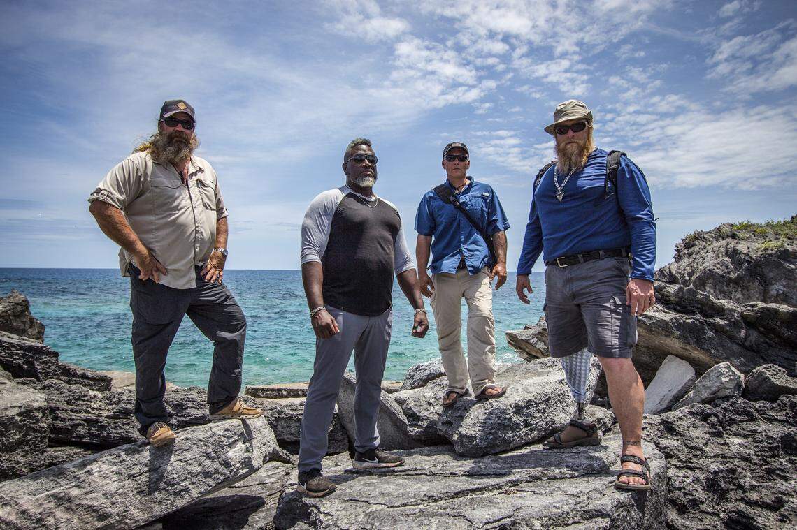 Moe Mottice, Chuck Meier, Mike Still and Dave Cziko walking up a reef.
