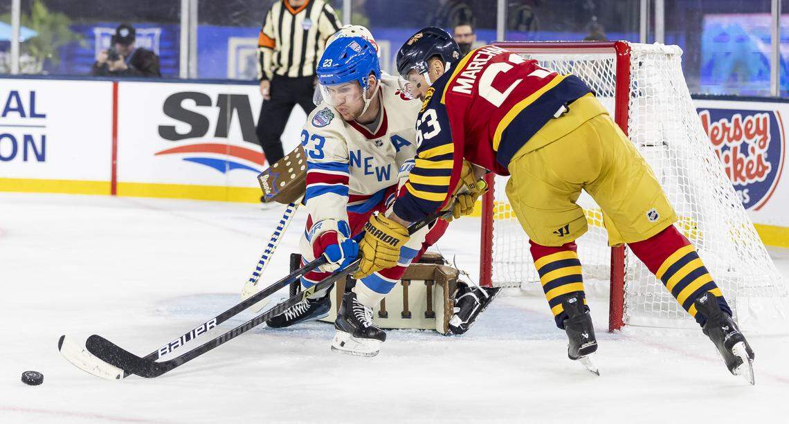 Florida Panthers left wing Brad Marchand (63) tries to score as New York Rangers defenseman Adam Fox (23) defends in the first period of their Winter Classic outdoor hockey game at loanDepot park on Friday, Jan. 2, 2026, in Miami, Fla.