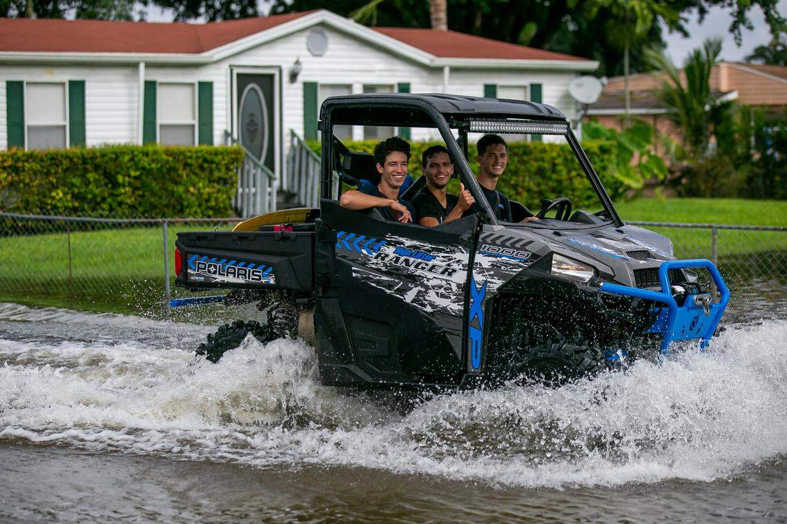 A UTV drives through a flooded street in a residential neighborhood near Davie, Florida, on Monday, Nov. 9, 2020, after Tropical Storm Eta dumped rain on South Florida.