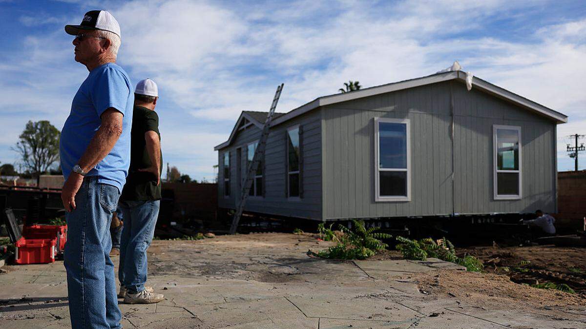 Workers help assemble a newly manufactured 1,200-square-foot ADU (accessory dwelling unit) on Thursday, Dec. 18, 2025, in Altadena, California. 