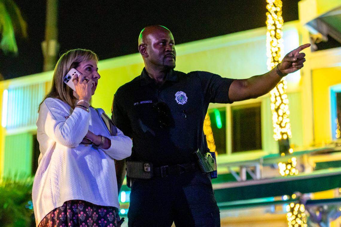 Miami Beach City Manager Alina Hudak stands with a police officer on Ocean Drive during spring break in Miami Beach, Florida, on Friday, March 15, 2024.