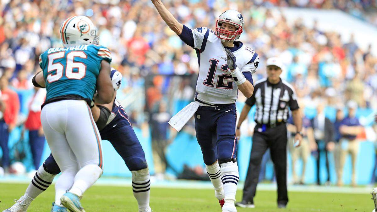 New England Patriots quarterback Tom Brady (12) finds wide receiver Julian Edelman for the touchdown, breaking former NFL QB Peyton Manning’s all-time TD pass record in the first quarter as the Miami Dolphins host the New England Patriots at Hard Rock Stadium in Miami Gardens on Sunday, December 9, 2018.