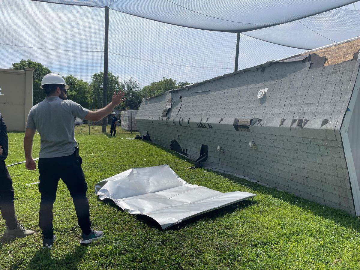 Researchers inspect the damage to a roof of a fallen manufactured home at Florida International University’s School of Engineering on May 13, 2026.