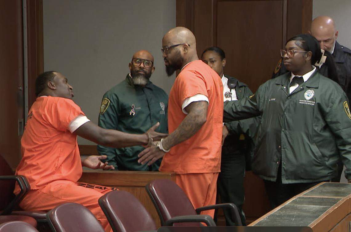 Roderick Martin, left, speaks to Reginald Jackson, right, as Jackson tries to storm out of court on Wednesday, April 22, 2026.