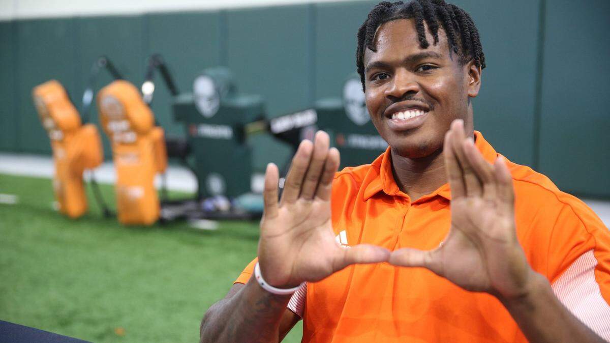 Miami Hurricanes defensive end Mitchell Agude flashes the U during Media Day in the Carol Soffer Indoor Practice Facility at the University of Miami on Tuesday, August 2, 2022.