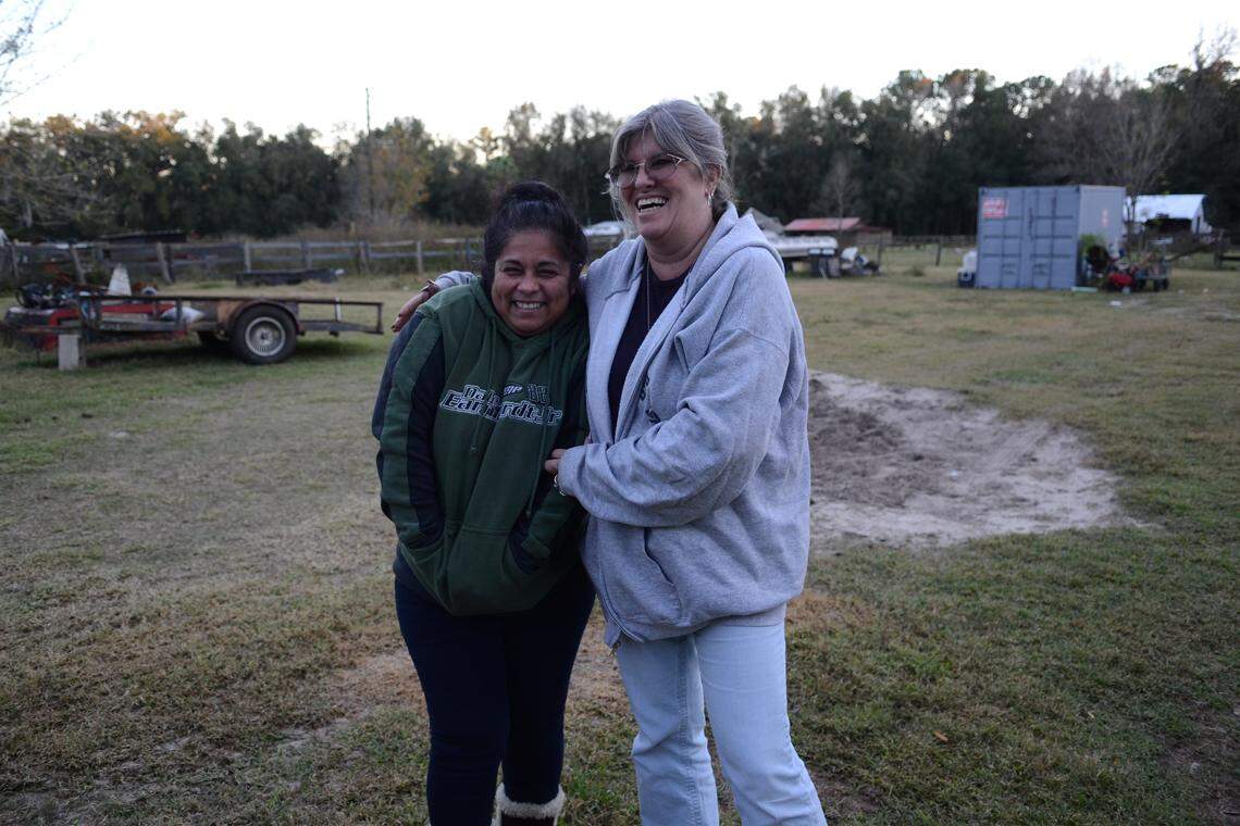 Miriam Flores and Linda Lawson crack jokes on the land between their homes. Flores, who lives with her family just a few hundred yards from Lawson in a mobile home, wasn’t notified about contaminated water in her well. Lawson was. When Flores called the local health departments, they told her that they thought the issue was “nothing,” she recalled.