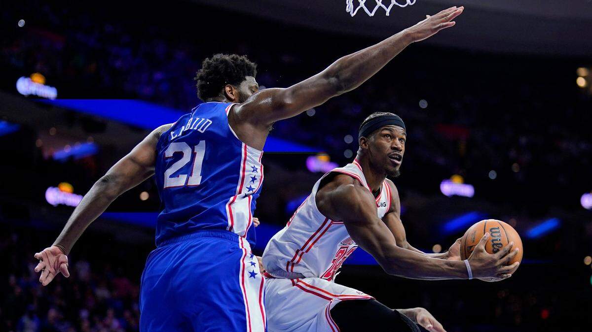 Miami Heat’s Jimmy Butler, right, goes up for a shot against Philadelphia 76ers’ Joel Embiid during the second half of an NBA basketball game, Monday, Feb. 27, 2023, in Philadelphia.