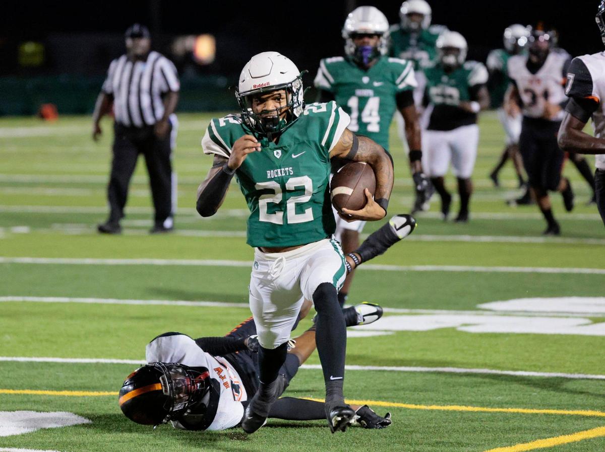 Miami Central Senior High School Rockets running back Jonathan Harris (22) attempts to break a tackle by Booker T. Washington Senior High School defensive back Antonio Branch (39) in the first half at Traz Powell Stadium on Friday, September 9, 2022.
