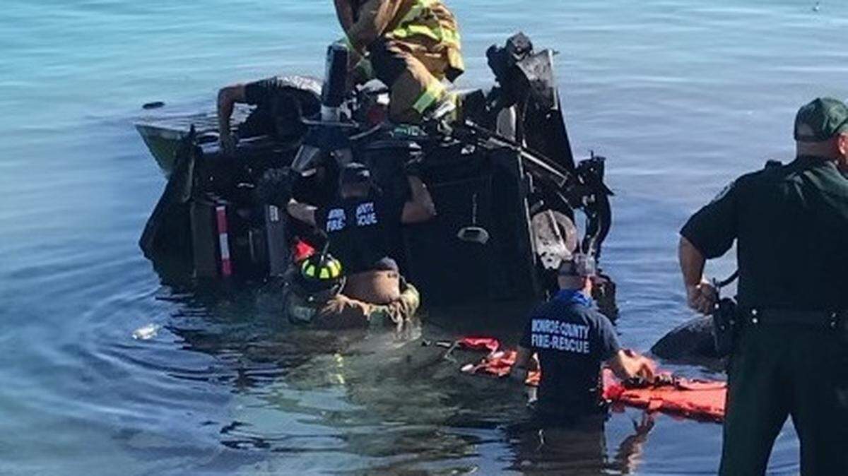 Monroe County Fire Rescue workers try to remove a driver trapped in a dump truck that went into the water off U.S. 1 on the morning of July 22, 2021.