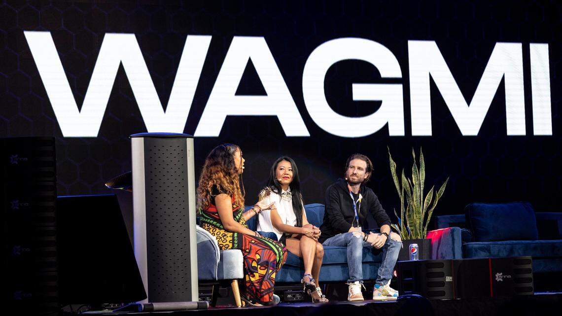 Left to right, panelists Ros Gold-Onwude, Swan Sit and Will Weinraub discuss NFTs during a panel discussion titled NFT 101 at the NFT BZL event Nov. 30, 2021, at FTX Arena in Miami. “WAGMI” stands for “We’re all going to make it.”