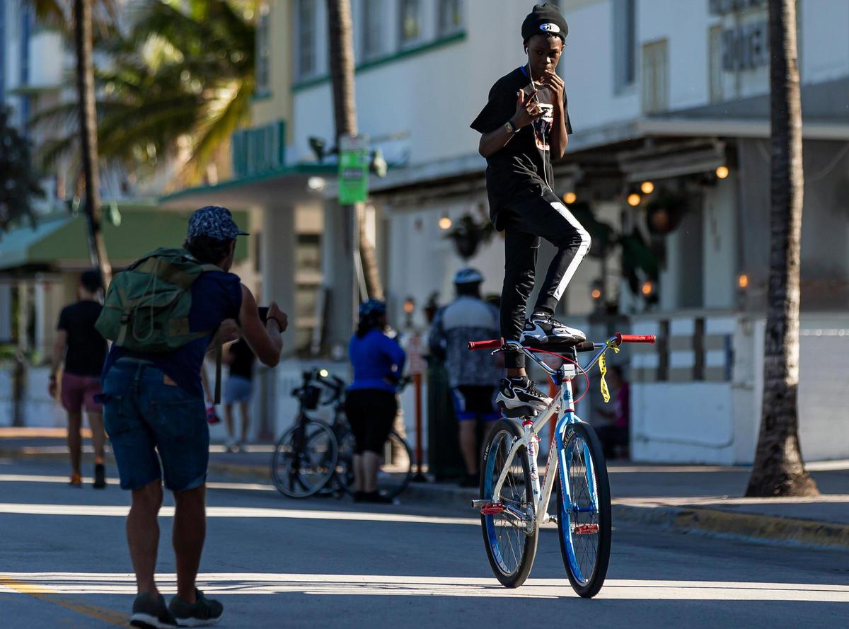 A biker makes his way down Ocean Drive on Miami Beach after the street was closed to vehicles, from 5th to 15th Street.