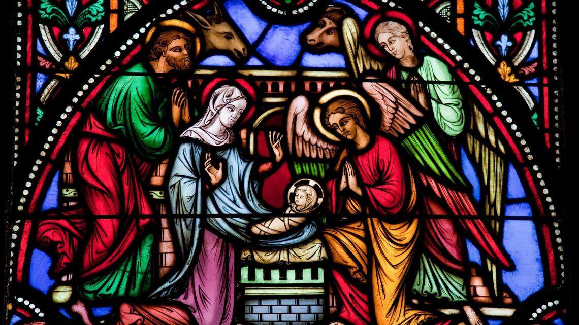 A stained-glass window depicts Joseph, the Virgin Mary and baby Jesus, who was born in a manger in Bethlehem on Christmas Day, Dec. 25.