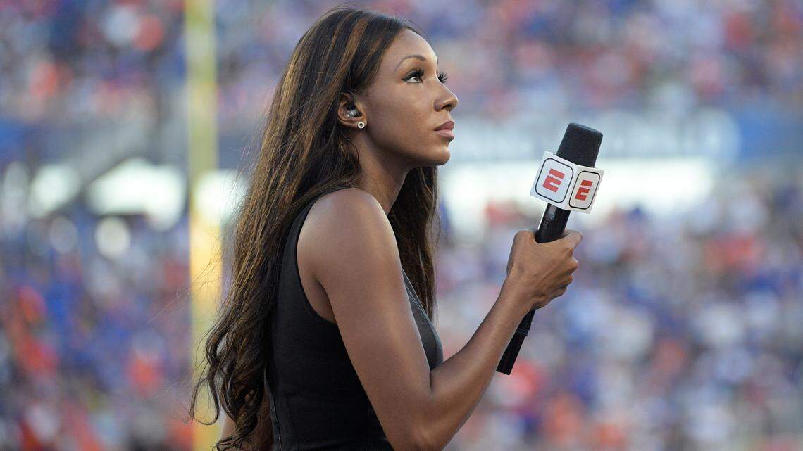 ESPN’s Maria Taylor works from the sideline during the first half of an NCAA college football game between Miami and Florida Saturday, Aug. 24, 2019, in Orlando, Fla. (AP Photo/Phelan M. Ebenhack)